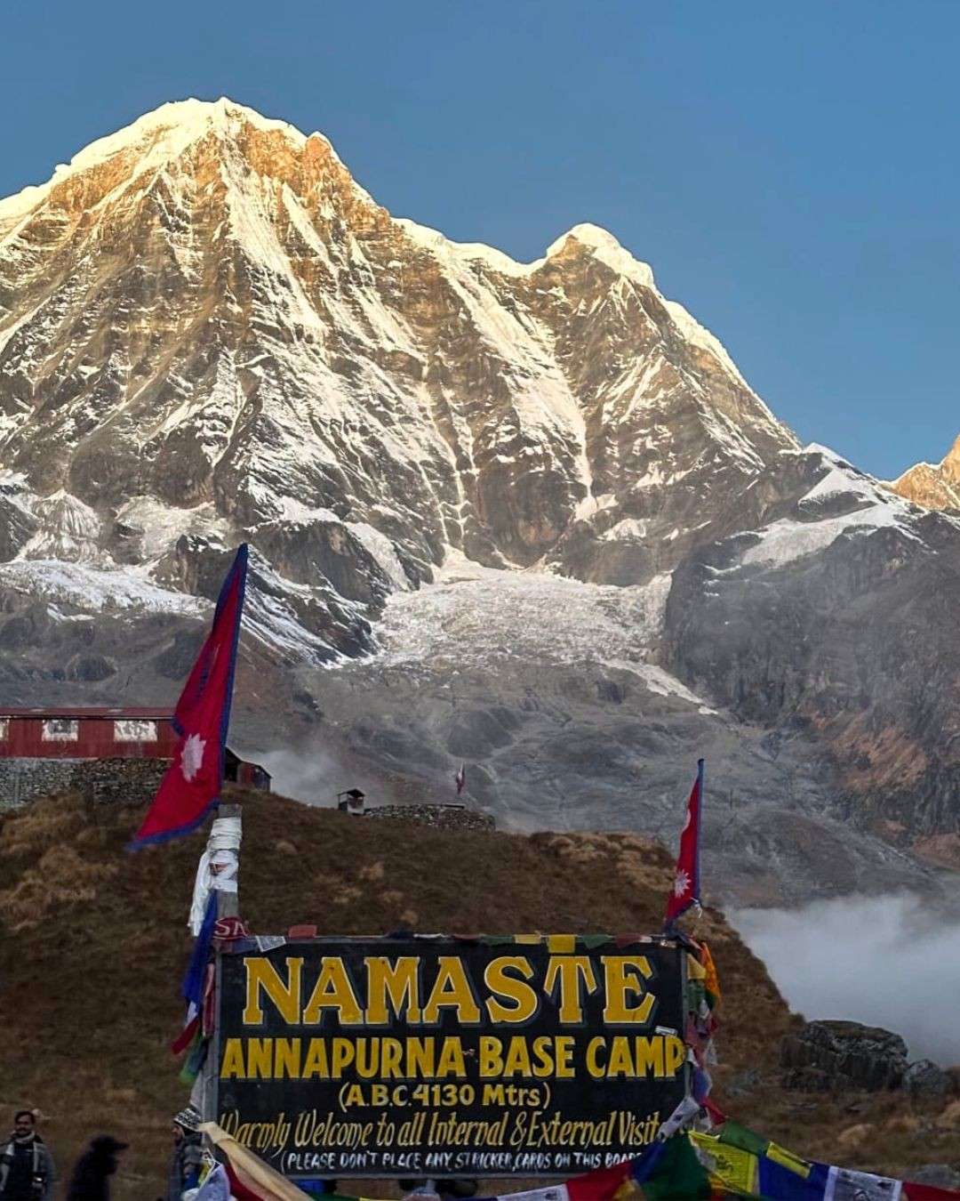 Welcome Namaste signboard with prayer flags at Annapurna Base Camp arrival, Nepal ABC trek