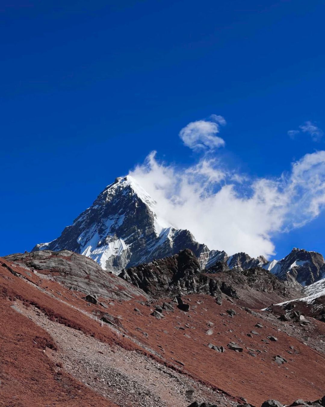Prayer flags on rocky peak, Khopra Ridge Trek