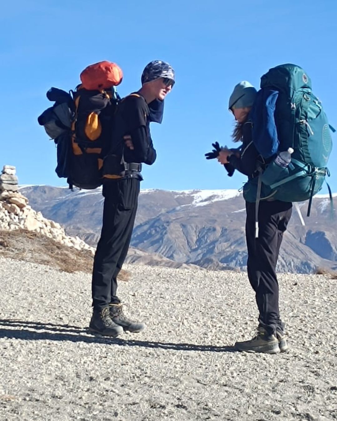 Trekkers hiking on trail in Lower Mustang Nepal with mountain views