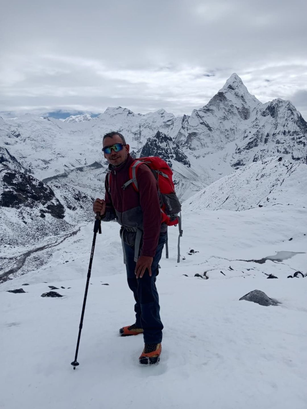 Trekker walking through snow on high-altitude trail during Everest Three Passes Trek